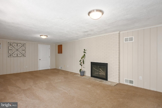 unfurnished living room with visible vents, carpet flooring, and a brick fireplace