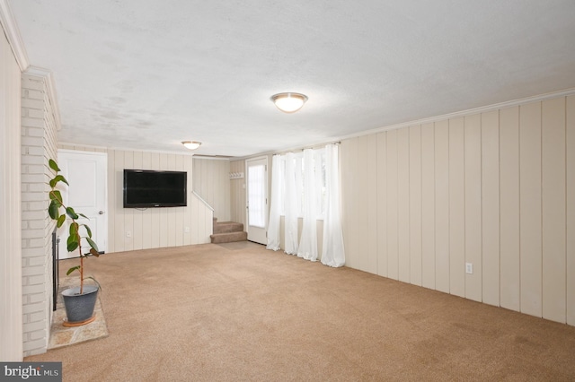 unfurnished living room with stairs and carpet floors