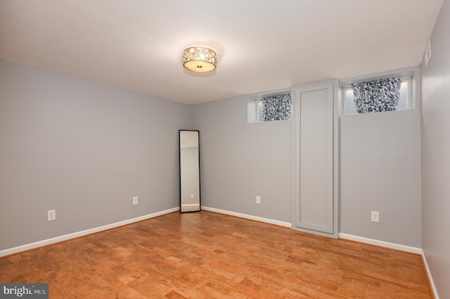 unfurnished room featuring light wood-type flooring and baseboards