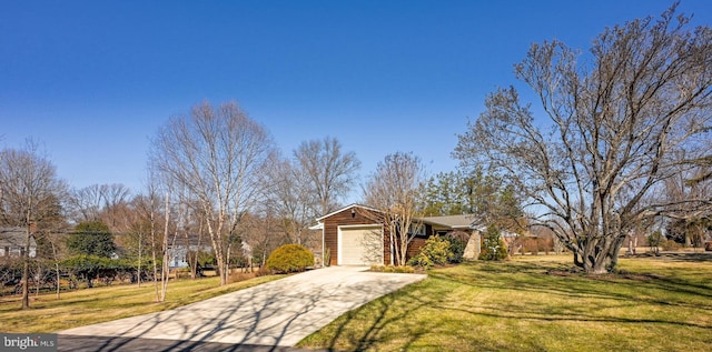 view of front of property with a garage, concrete driveway, and a front lawn