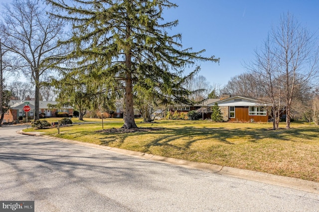 exterior space with a front lawn and a chimney