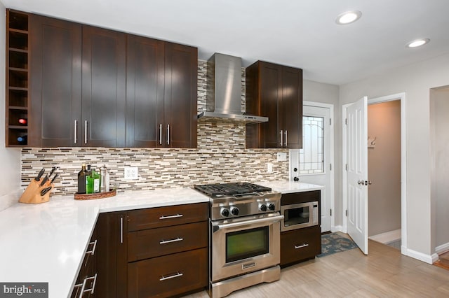 kitchen with open shelves, decorative backsplash, light countertops, high end stainless steel range oven, and wall chimney exhaust hood