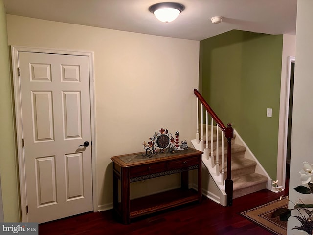 stairs featuring baseboards and wood finished floors