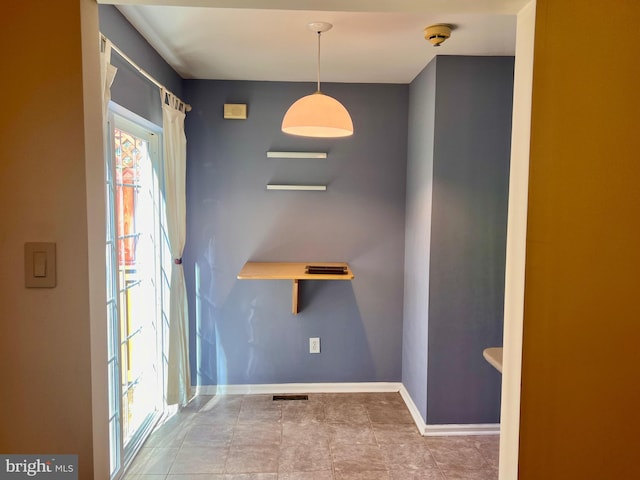 empty room featuring visible vents and baseboards