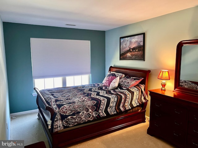 bedroom featuring visible vents, carpet floors, and baseboards