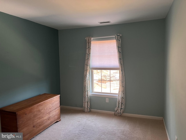 unfurnished room featuring visible vents, baseboards, and carpet flooring