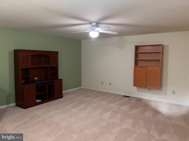 unfurnished living room with baseboards, light carpet, visible vents, and a ceiling fan