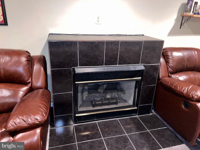 interior details featuring a tile fireplace