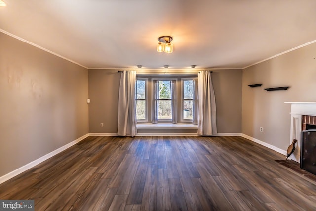 unfurnished living room with dark wood-style floors, a brick fireplace, and baseboards