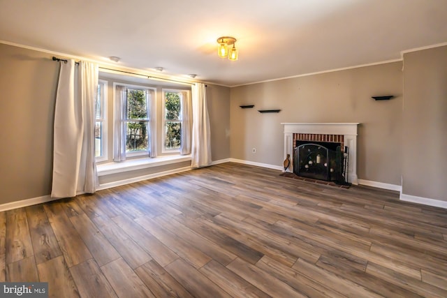 unfurnished living room featuring baseboards, dark wood-type flooring, a fireplace, and crown molding