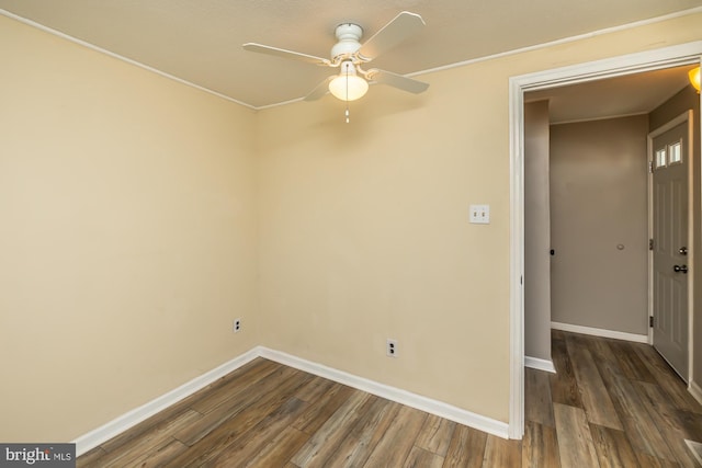 unfurnished room featuring baseboards, dark wood-type flooring, and ceiling fan