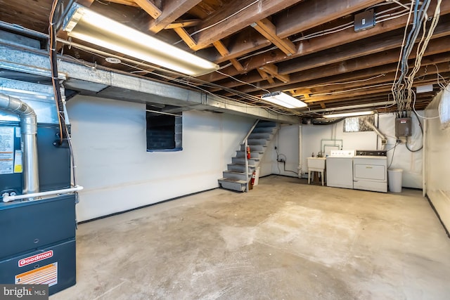 unfinished below grade area featuring stairs, washing machine and dryer, and a sink