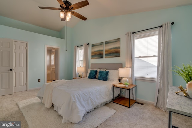 bedroom with visible vents, baseboards, carpet, vaulted ceiling, and ensuite bath