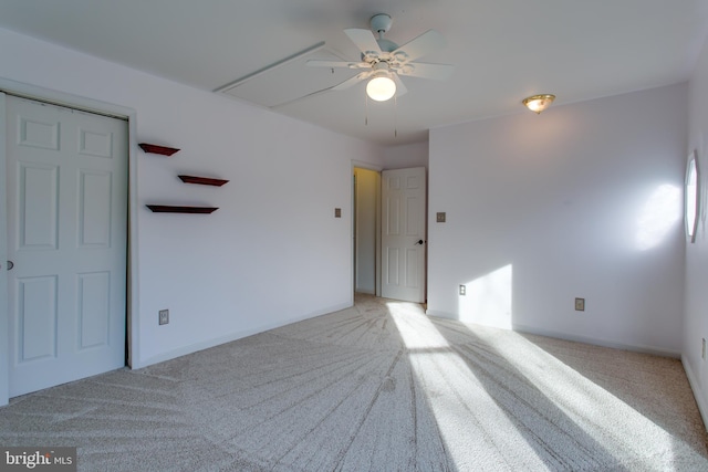 unfurnished room with baseboards, light carpet, and ceiling fan