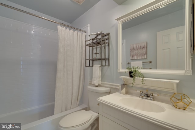 bathroom featuring vanity, toilet, and shower / bath combo with shower curtain