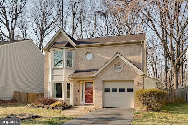 traditional home with driveway, fence, brick siding, and roof with shingles