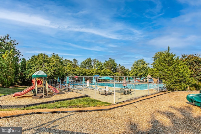 view of pool featuring playground community