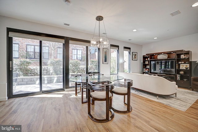 dining area featuring a notable chandelier, recessed lighting, wood finished floors, and visible vents