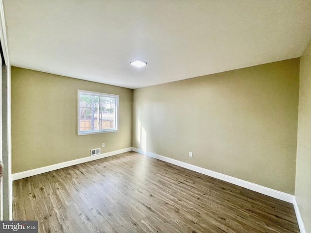 interior space featuring wood finished floors, visible vents, and baseboards