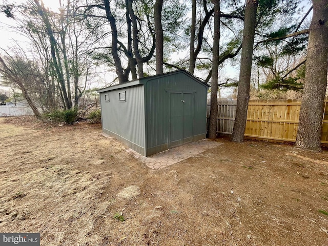 view of shed with fence