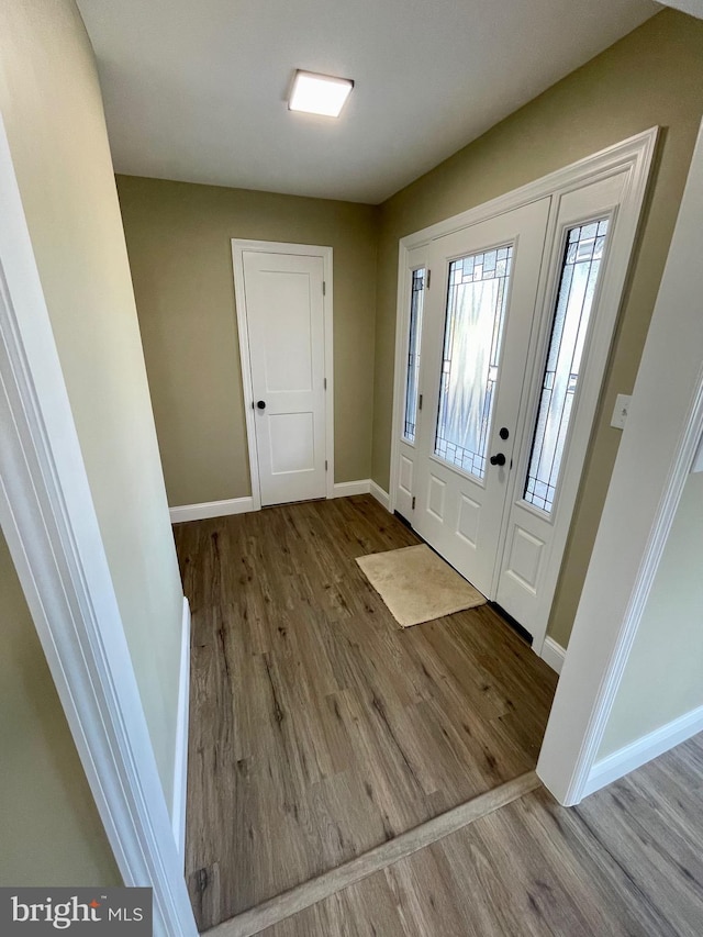 entrance foyer featuring wood finished floors and baseboards