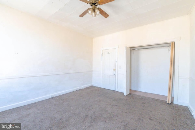 unfurnished bedroom featuring a closet, carpet floors, baseboards, and a ceiling fan