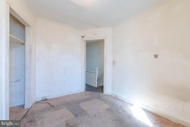 unfurnished bedroom with unfinished concrete flooring and ornamental molding