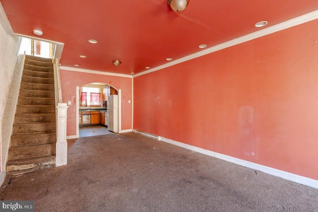 unfurnished living room featuring carpet, baseboards, arched walkways, ornamental molding, and stairs