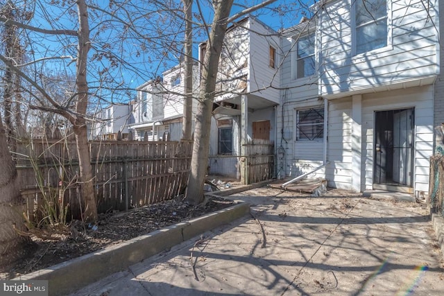 view of side of home featuring fence