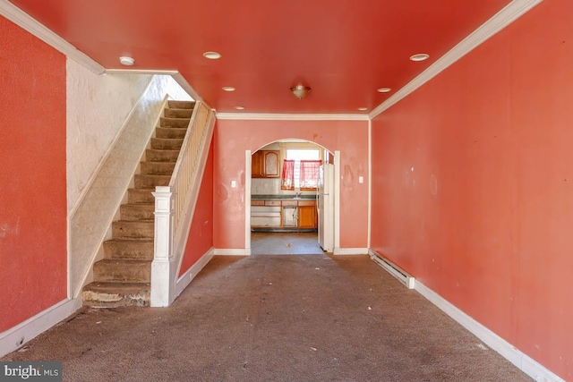 interior space featuring baseboards, carpet, arched walkways, and ornamental molding