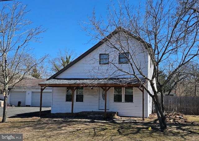123 S 9th St, Millville, NJ 08332 - view of front of property with an outbuilding, covered porch, a garage, and fence