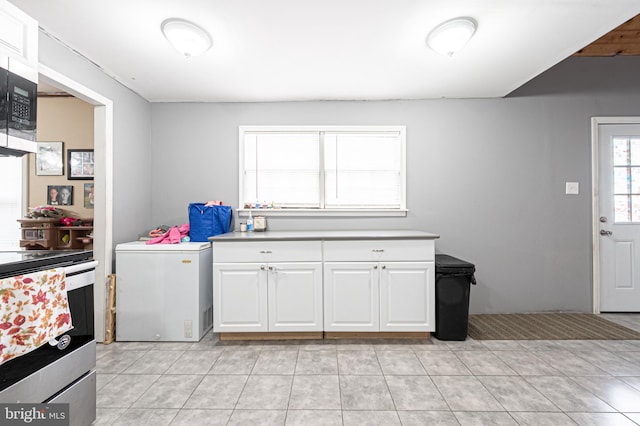 123 S 9th St, Millville, NJ 08332 - kitchen featuring light countertops, white cabinets, light tile patterned flooring, and appliances with stainless steel finishes