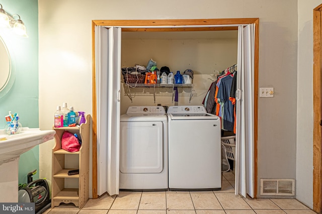 123 S 9th St, Millville, NJ 08332 - laundry area with washing machine and clothes dryer, visible vents, laundry area, and light tile patterned floors