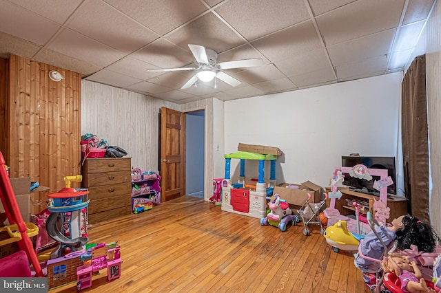 123 S 9th St, Millville, NJ 08332 - playroom with a drop ceiling, wooden walls, and hardwood / wood-style floors