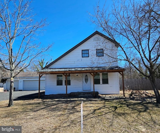 123 S 9th St, Millville, NJ 08332 - view of front facade featuring a garage, an outdoor structure, and fence