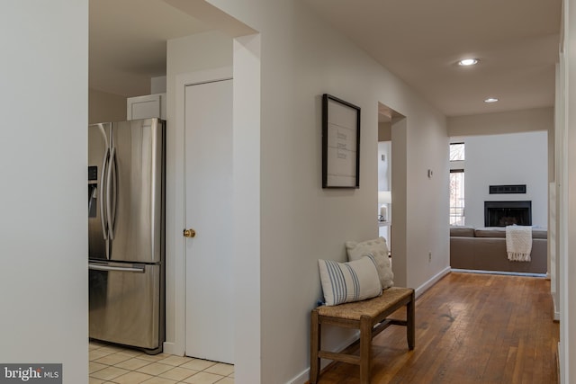 hall with recessed lighting, baseboards, and light wood-style floors