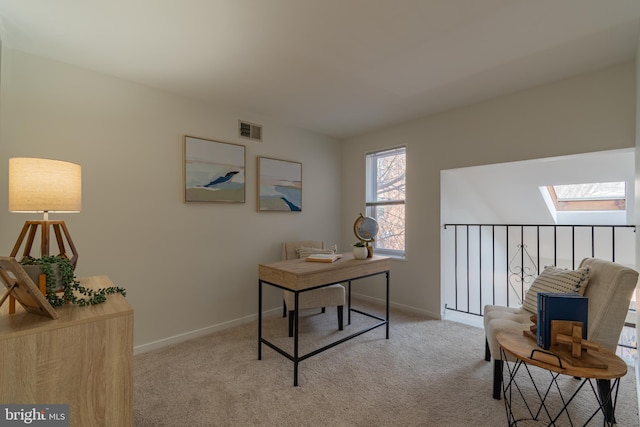 home office featuring visible vents, light colored carpet, and baseboards