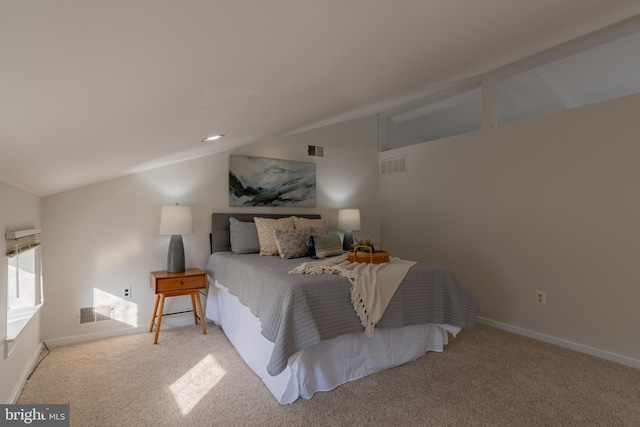 bedroom featuring visible vents, carpet floors, and vaulted ceiling