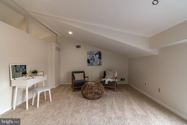 living area with visible vents, carpet flooring, baseboards, and vaulted ceiling