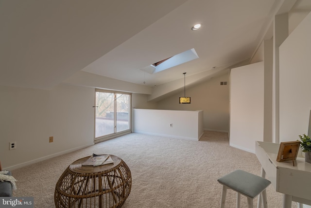 interior space featuring vaulted ceiling with skylight, carpet flooring, recessed lighting, and baseboards