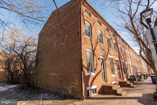 view of property exterior featuring brick siding and entry steps