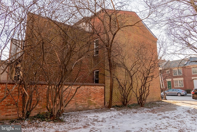 view of side of home with brick siding