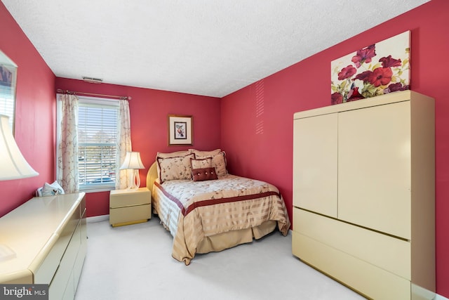 carpeted bedroom with a textured ceiling