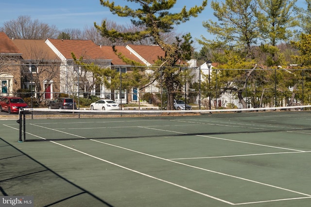 view of tennis court featuring fence