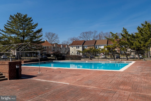 pool featuring a residential view and fence