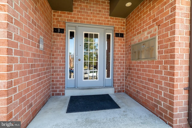 property entrance featuring brick siding