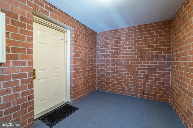 property entrance with brick siding