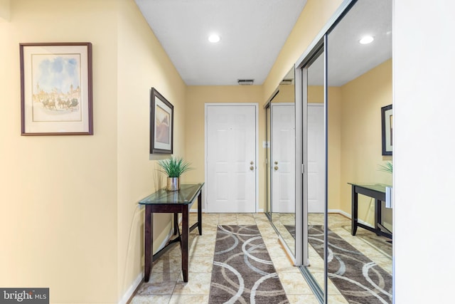 interior space featuring recessed lighting, visible vents, and baseboards