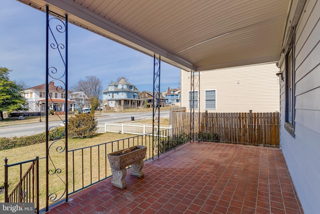 view of patio / terrace featuring fence and a residential view