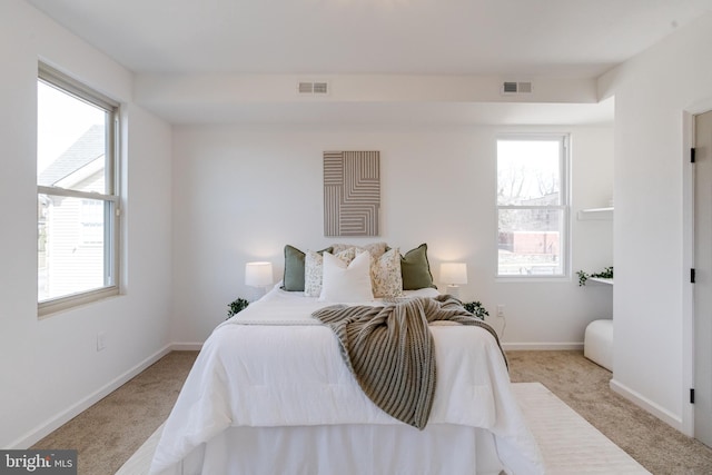 bedroom with carpet flooring, baseboards, and visible vents